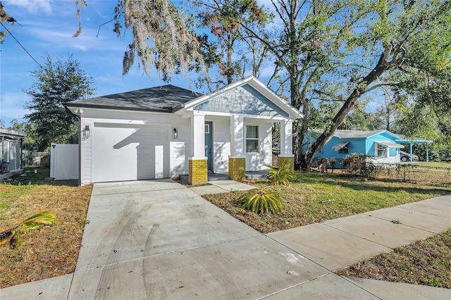 view of front facade featuring a front yard, a porch, and a garage