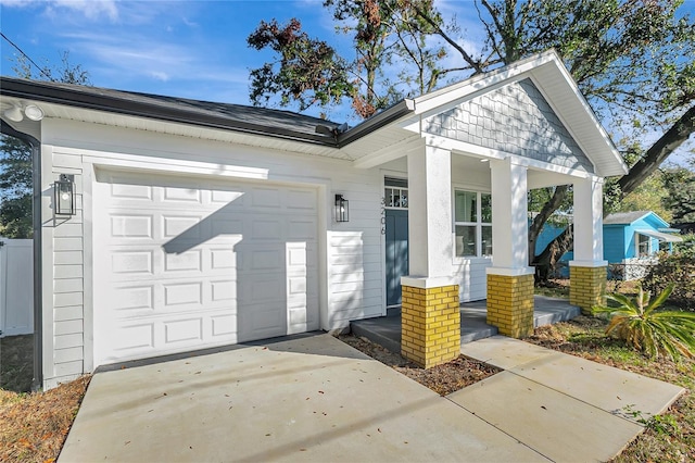 doorway to property featuring covered porch and a garage