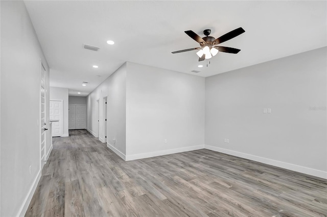 spare room with light hardwood / wood-style floors and ceiling fan