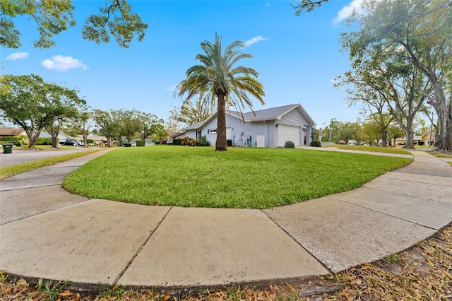 view of property exterior with a garage and a lawn