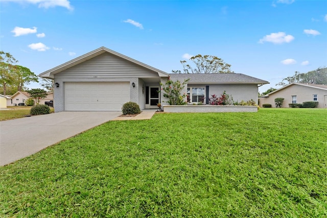 ranch-style house featuring a garage and a front lawn