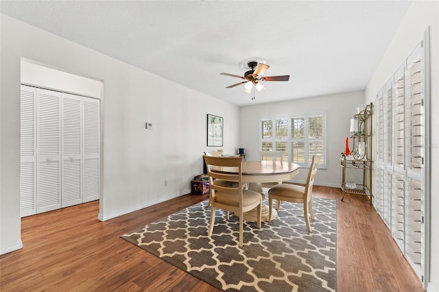 dining area with ceiling fan and hardwood / wood-style flooring