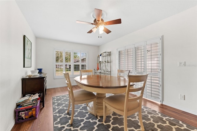 dining space featuring ceiling fan and dark wood-type flooring