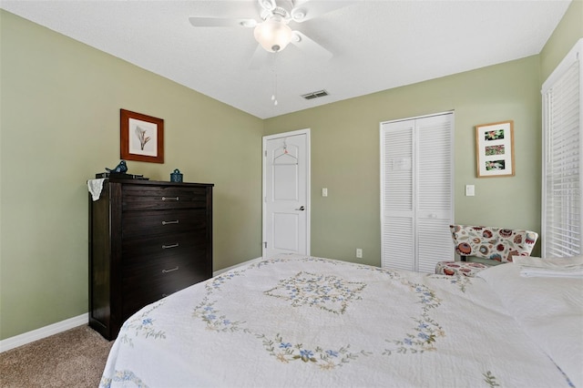 bedroom featuring ceiling fan, a closet, and carpet