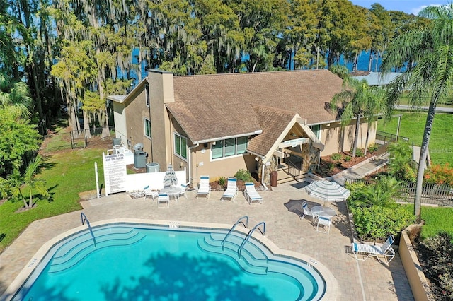 view of swimming pool featuring a patio area and a lawn