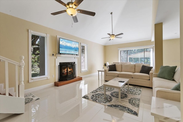 tiled living room featuring ceiling fan and a wealth of natural light