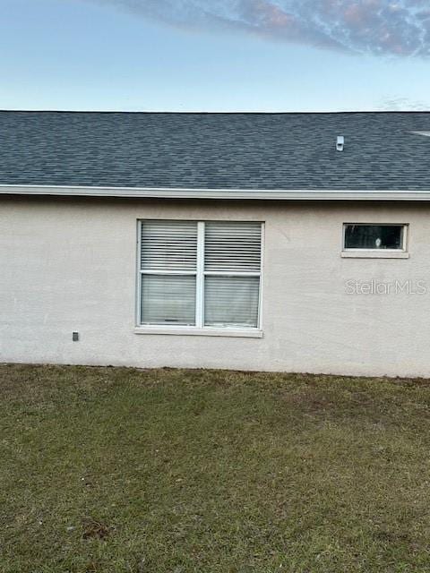 view of side of home featuring a lawn