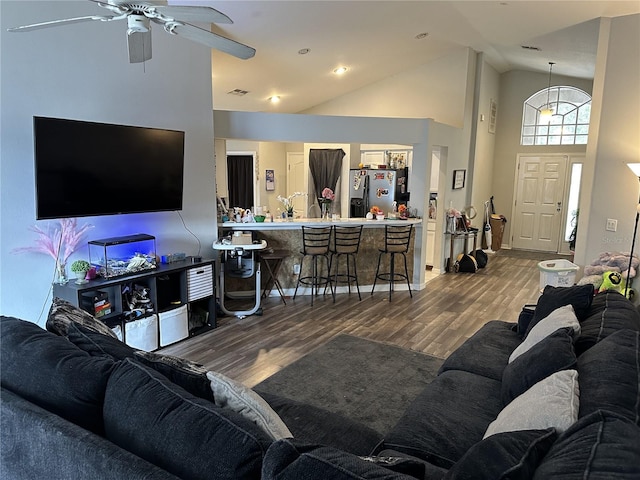 living room with high vaulted ceiling, hardwood / wood-style floors, and ceiling fan