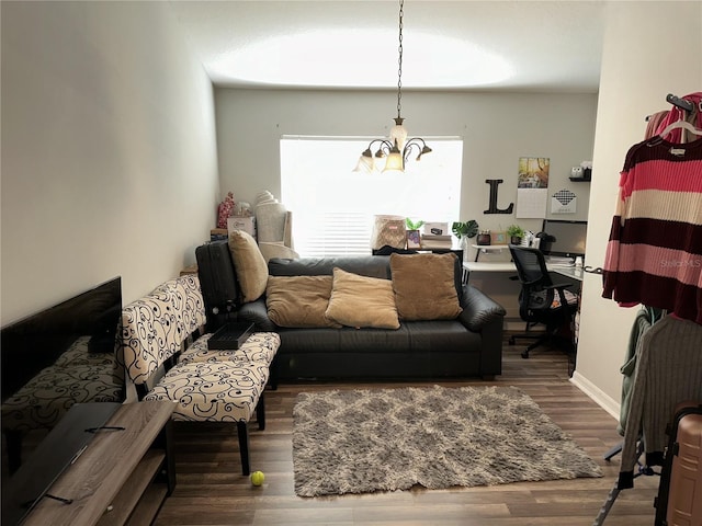 living room with dark hardwood / wood-style flooring and a chandelier