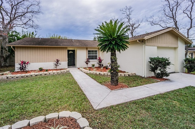 single story home with a front lawn and a garage