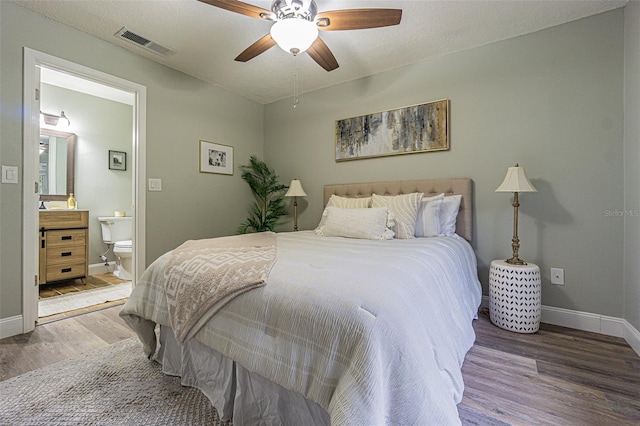 bedroom featuring ensuite bath, ceiling fan, and hardwood / wood-style floors