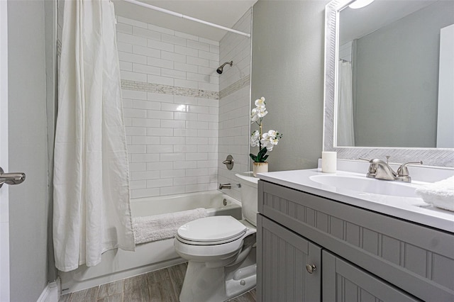 full bathroom featuring shower / tub combo, vanity, and toilet