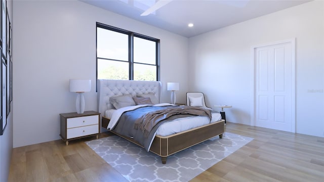 bedroom with ceiling fan and light wood-type flooring