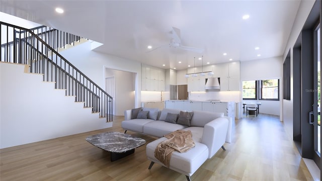 living room featuring ceiling fan and light hardwood / wood-style floors