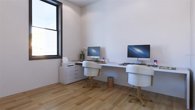 office space with light wood-type flooring and built in desk