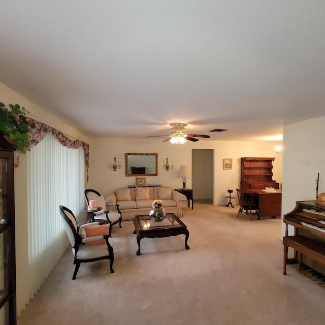 carpeted living room with ceiling fan