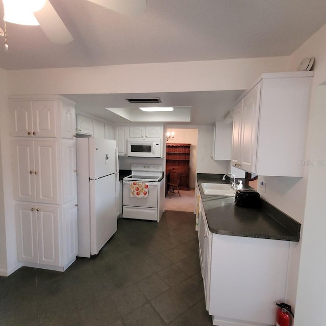 kitchen featuring ceiling fan, sink, white appliances, and white cabinetry