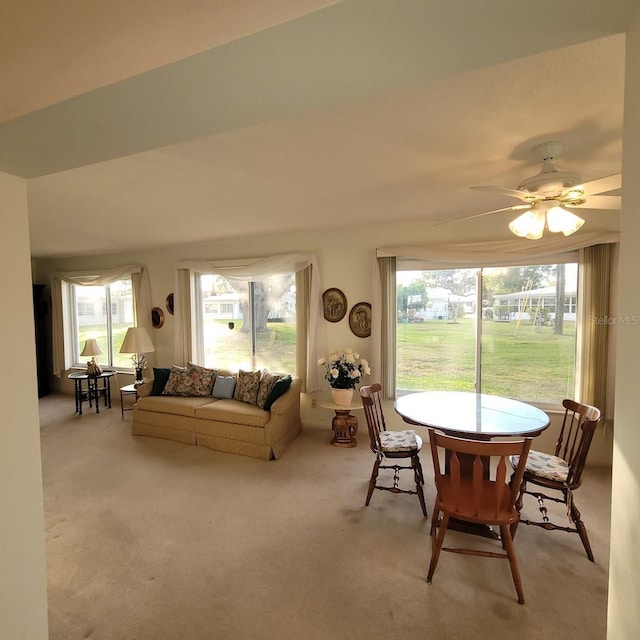 carpeted living room with ceiling fan