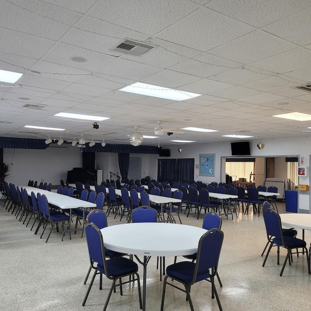 dining space with a drop ceiling