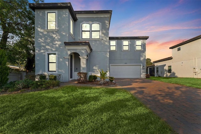 view of front of property with a lawn and a garage