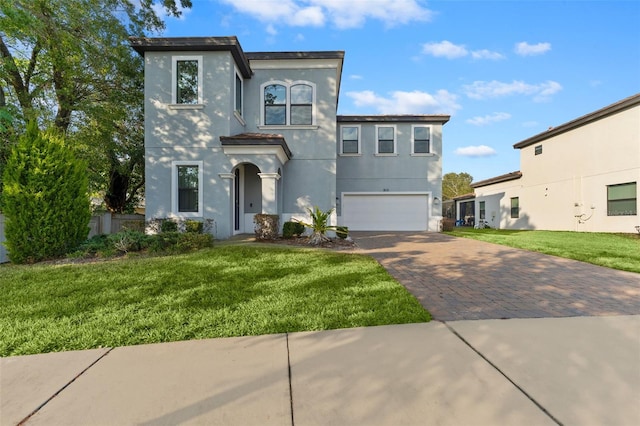 view of front of property with a front yard and a garage