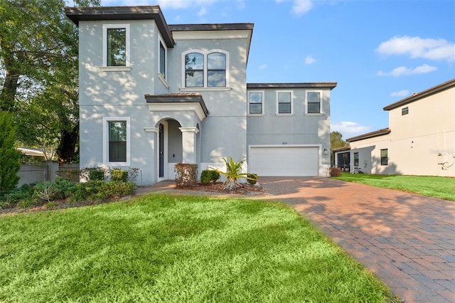 view of front of home with a front yard and a garage