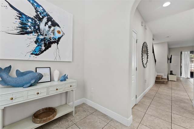 hall featuring light tile patterned flooring