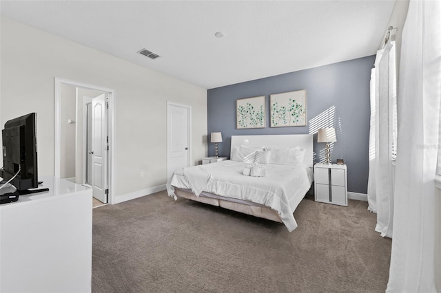 bedroom with dark colored carpet