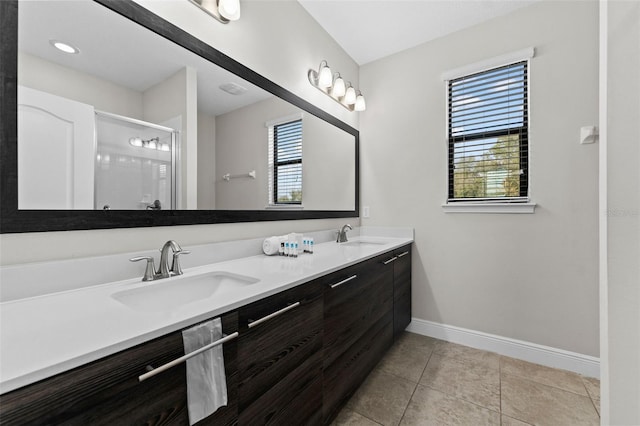 bathroom with vanity, tile patterned floors, a shower with shower door, and a wealth of natural light