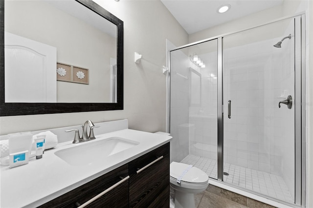 bathroom featuring toilet, an enclosed shower, and vanity