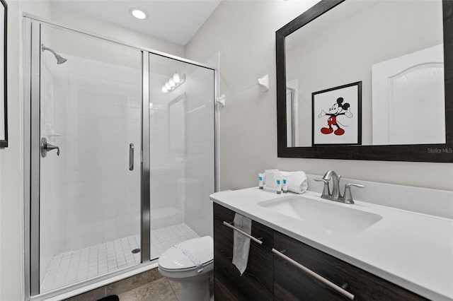 bathroom with toilet, walk in shower, and vanity