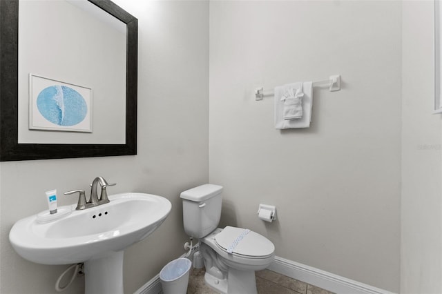 bathroom featuring sink, tile patterned flooring, and toilet