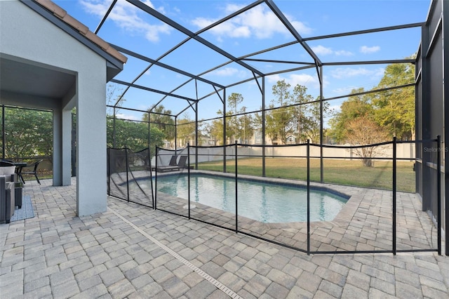 view of swimming pool with a lanai, a patio, and a yard