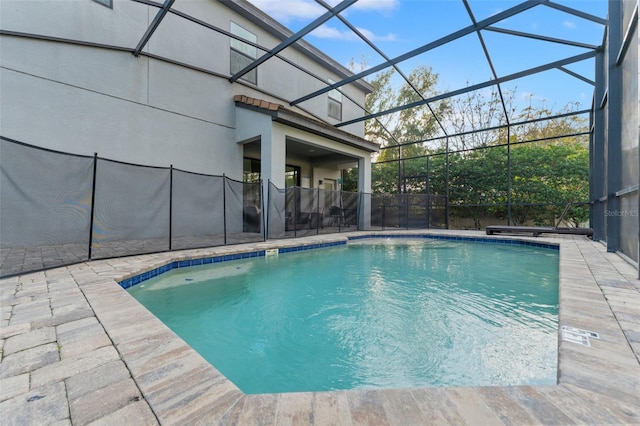 view of swimming pool featuring a lanai and a patio