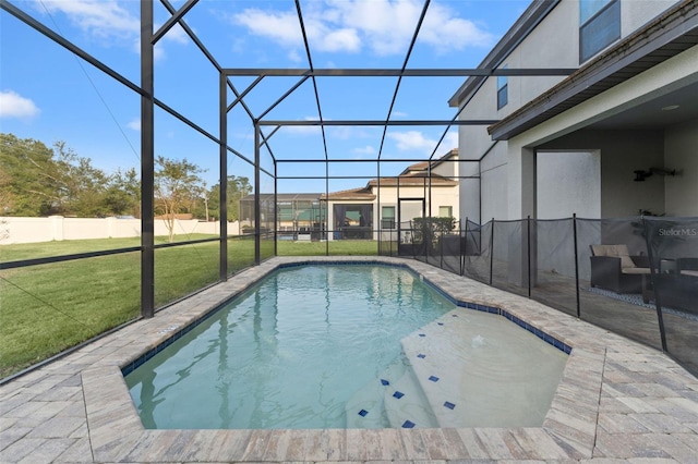 view of pool featuring a lanai, a patio, and a lawn