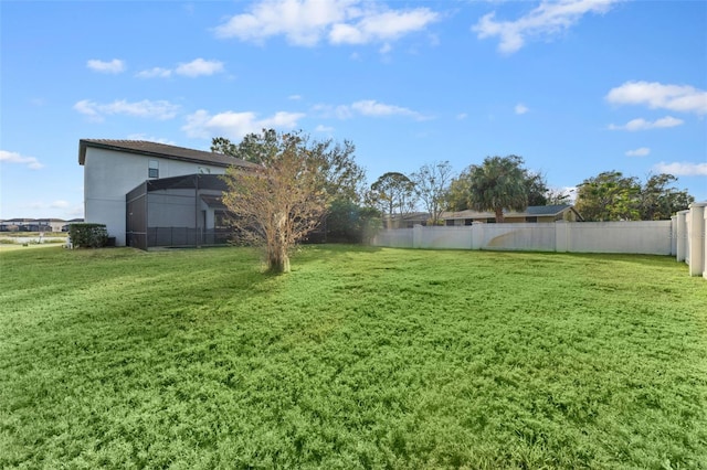 view of yard with glass enclosure