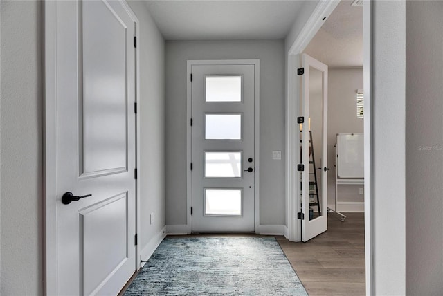 entryway with a wealth of natural light and light hardwood / wood-style floors