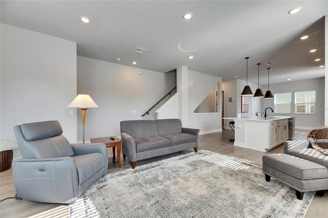 living room featuring sink and light wood-type flooring