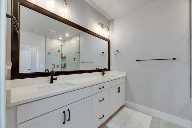 bathroom with a shower with door, tile patterned floors, and vanity