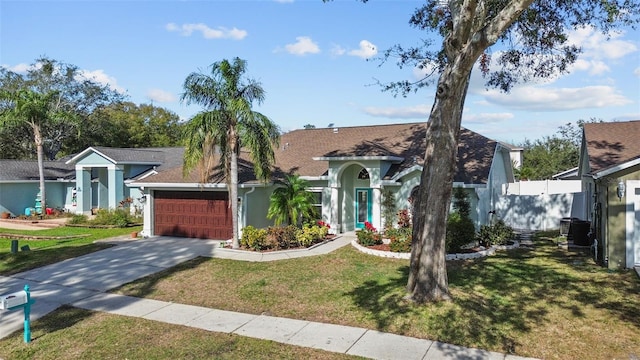 view of front facade with a garage and a front lawn