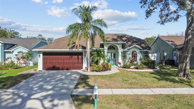 view of front of home featuring a garage, central AC unit, and a front yard