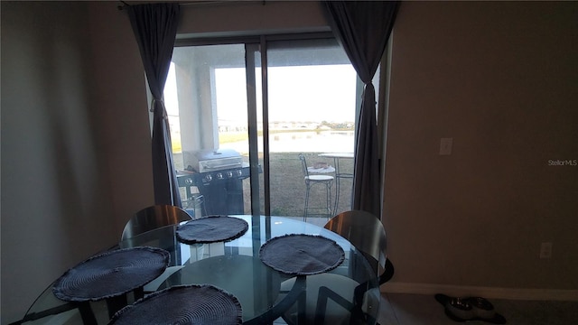 dining room featuring a water view