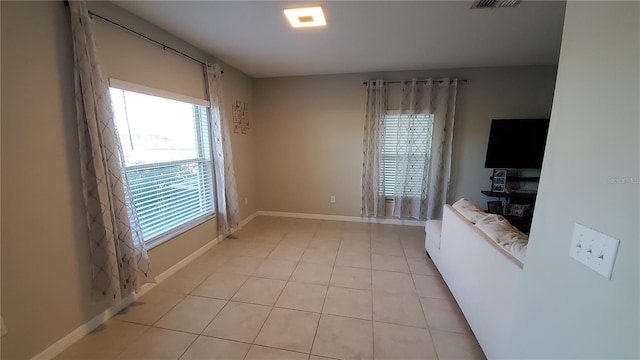 unfurnished living room with light tile patterned floors