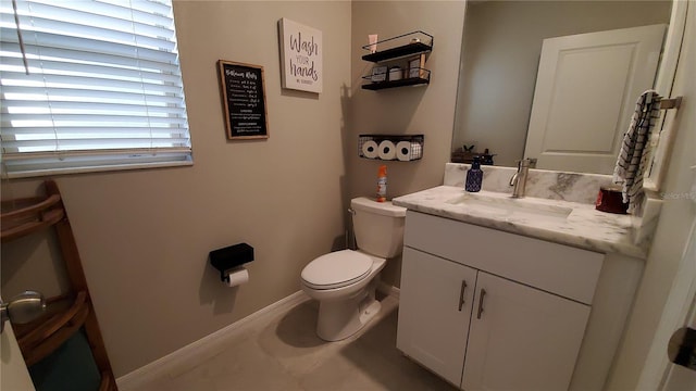 bathroom featuring tile patterned flooring, vanity, and toilet