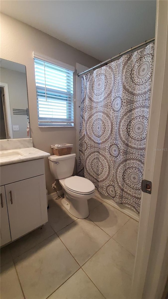 bathroom featuring walk in shower, tile patterned flooring, vanity, and toilet