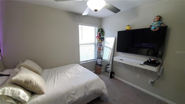 carpeted bedroom with multiple windows and ceiling fan