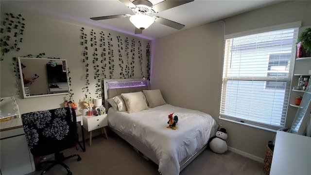 bedroom with multiple windows, light carpet, and ceiling fan