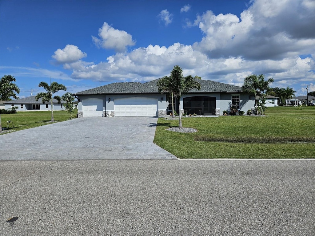 single story home with a front yard and a garage