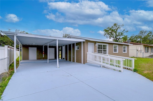 view of front of property with a front yard and a carport