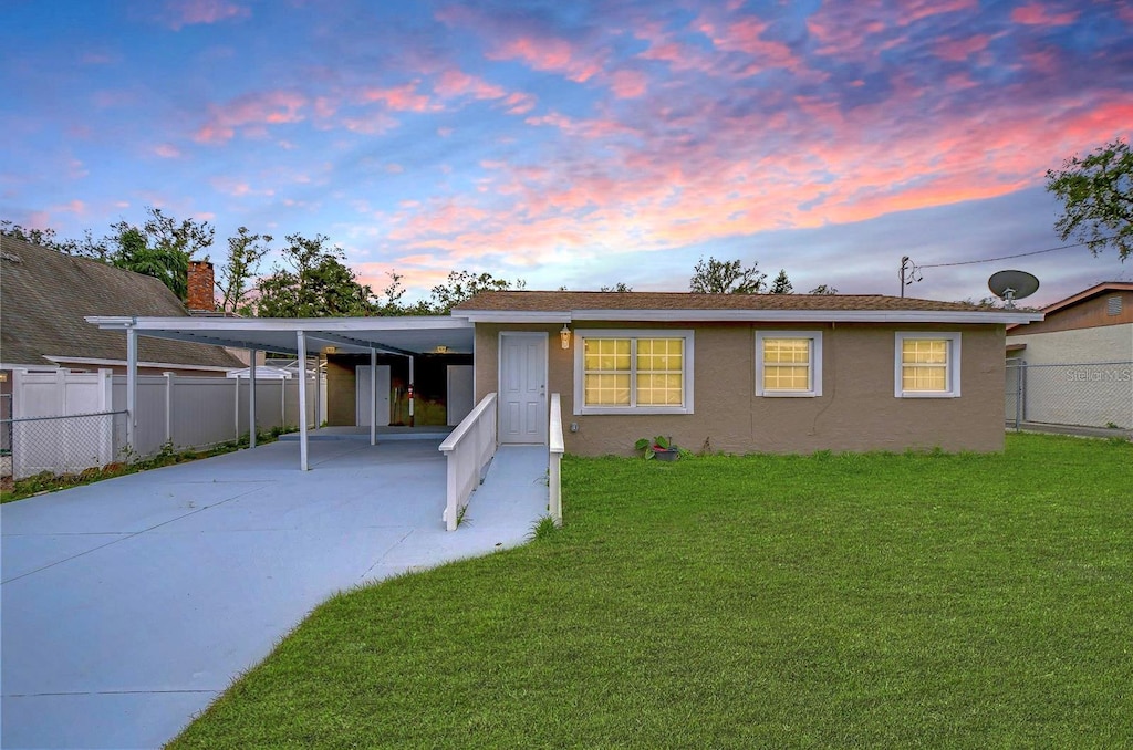 exterior space featuring a yard and a carport